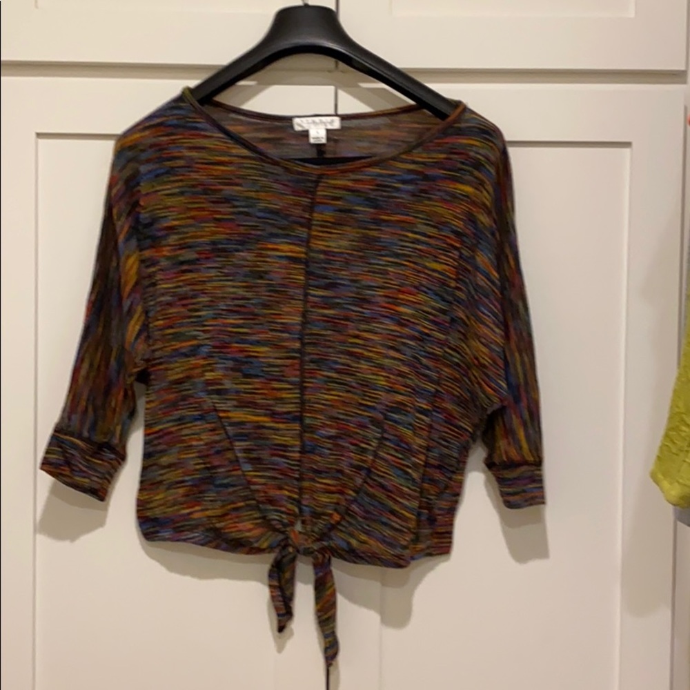 Light sweater top with tie.